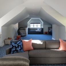 Playroom With Angled Ceiling, Sitting Area and Blue Carpet
