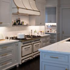 Kitchen With Dual Gas Ovens and French Country Range Hood