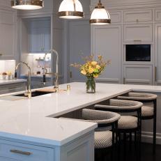 White Kitchen With Large Island and Industrial Pendant Lights