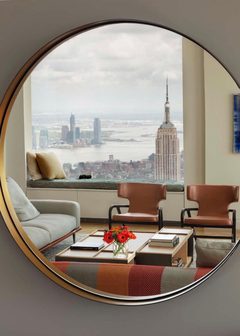 Picture Of Living Room Furniture And Skyline Reflected In Round Mirror