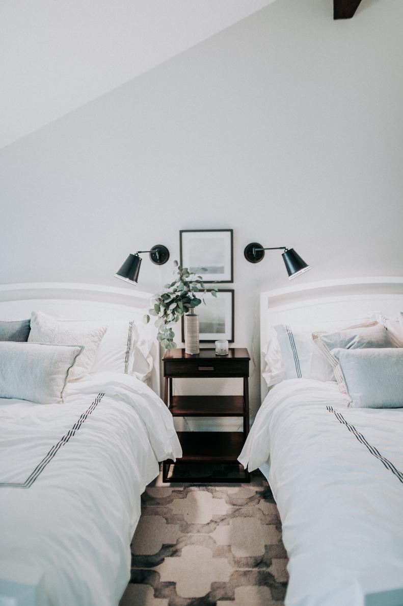 Two Guest Beds With Sconces And Shared Nightstand