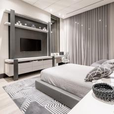 Gray Modern Master Bedroom With TV Wall