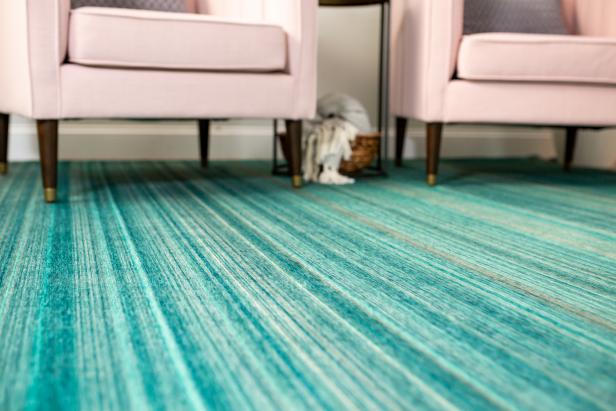 striped green rug and pink chairs