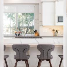 White Modern Kitchen With Gray Chairs