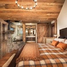 Rustic Master Bedroom With Plaid Bedspread