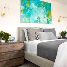 Master Bedroom Features Tailored Upholstered Bed and Oversized Nightstands
