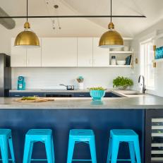 Modern Coastal Kitchen with Concrete Countertops and Turquoise Blue Stools 