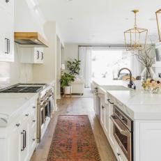 Bright White Kitchen With Brass Accents