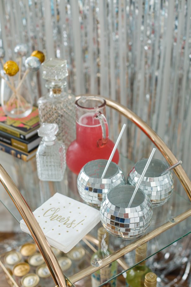 A Bar Cart Holding Three Disco Ball Glasses