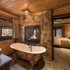 Rustic Master Bathroom with Clawfoot Tub and Fireplace 