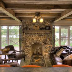 Rustic Living Room With French Doors and Stone Fireplace