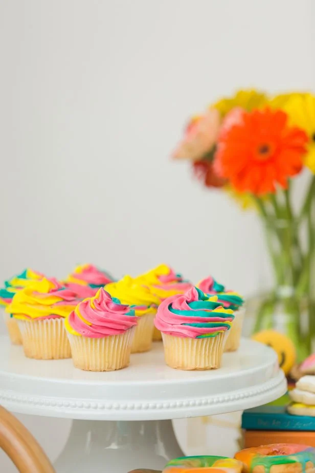 Pink, Green and Yellow Tie-Dye Icing on Top of a Cupcake