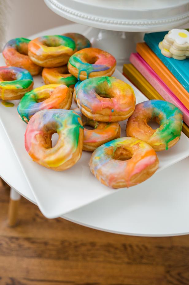 A White Platter Stacked High With Tie-Dye Doughnuts