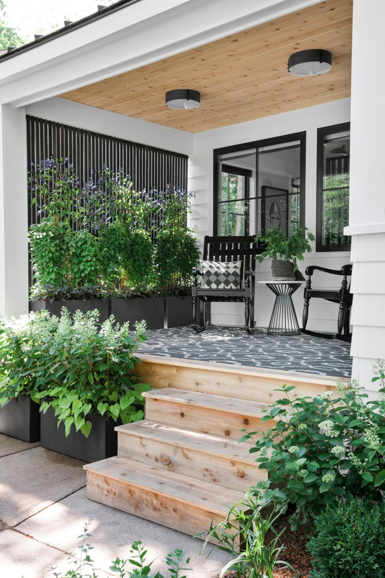 Natural-Finish Steps Lead to Covered Front Porch Sitting Area