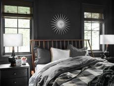 Bright White Clock on Wall Above Wood-Framed Bed With Neutral Bedding