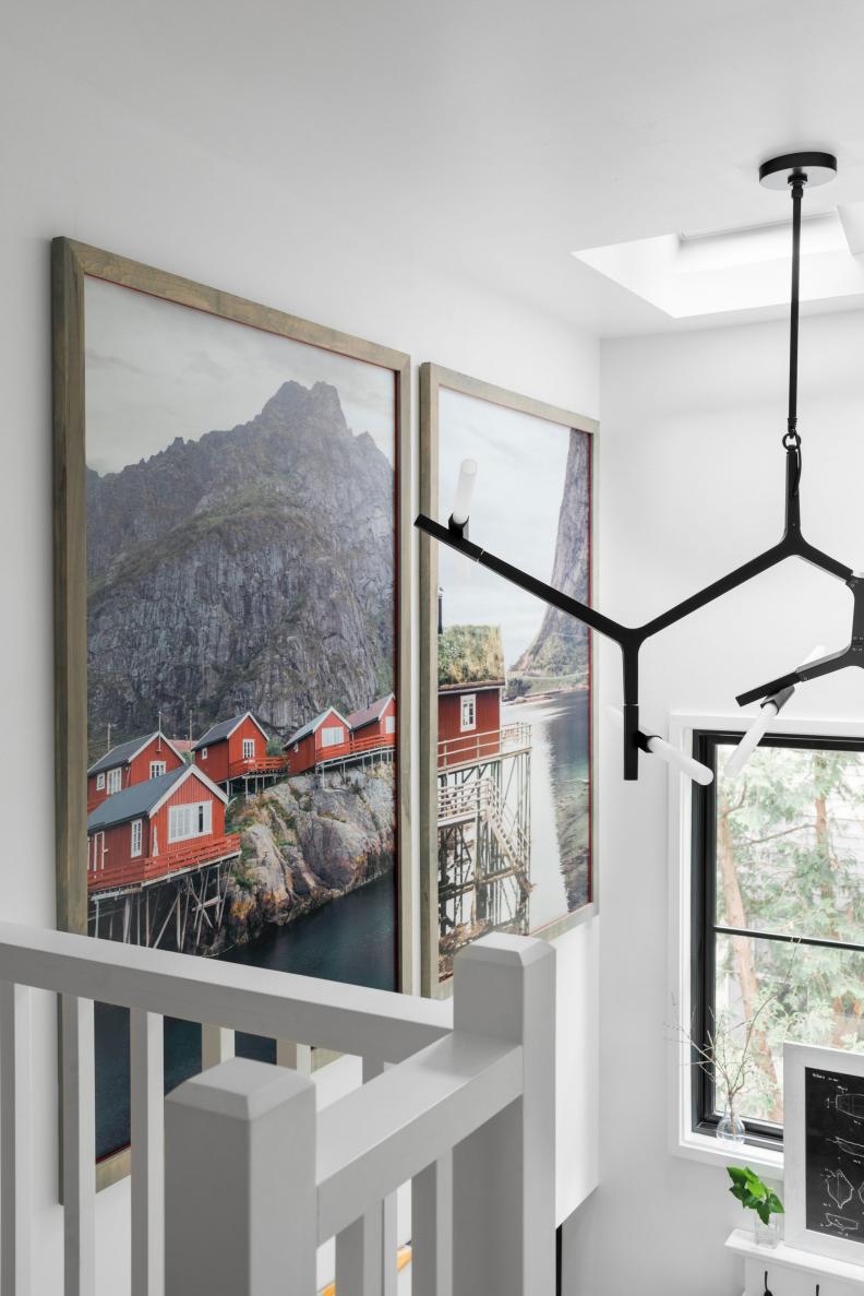 Large Framed Photos of Red Nordic Cabins in Bright White Stairwell
