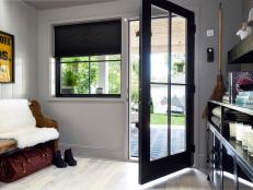 Black French Door Opening Into Gray Transitional Mudroom