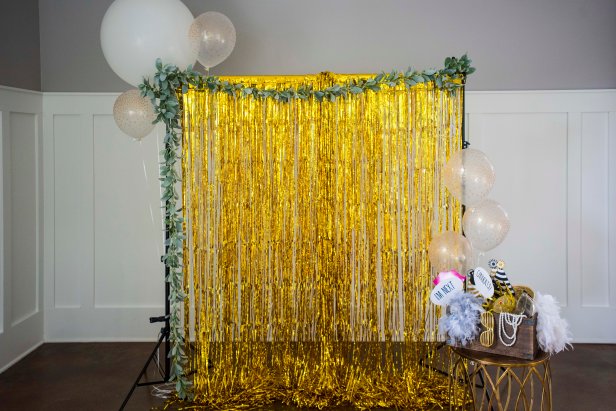 Make a DIY wedding photo booth for guests with silly props, balloons and a pretty backdrop using items from Amazon.