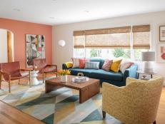 A terra-cotta-color wall brings in warmth year-round. “The tone shifts over the course of the day, like a sunset,” says Katie. The oversize art from Four Hands Art Studio makes it even more glorious. For seating, the dated brown sectional that dominated the space got replaced with a chic blue wool-blend sofa by American Leather, a curvy armchair by Taylor King, and two leather slingback chairs from Wisteria. Friends at the couple’s giant potluck dinners spill into here, so the large coffee table by Jonathan Charles Fine Furniture comes in handy. The rug is by Jaipur Living.