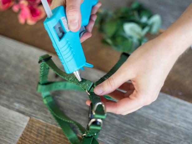 Heat up your glue gun and start gluing the flowers to the harness.