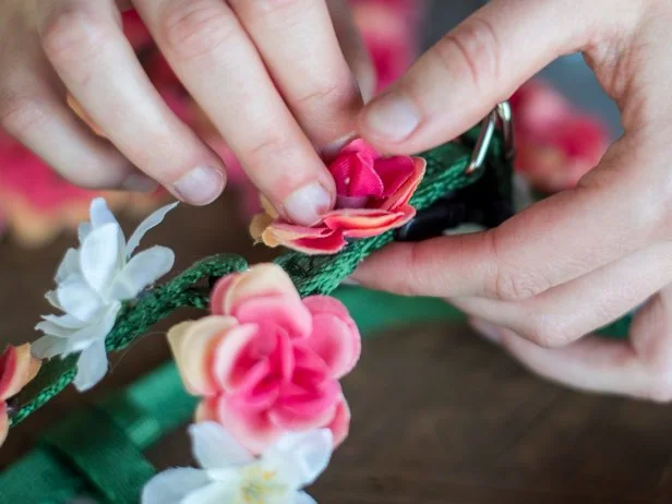 Heat up your glue gun and start gluing the flowers to the harness. We alternated between pink and white flowers, leaving varying amounts of space between them to fill in with leaves.