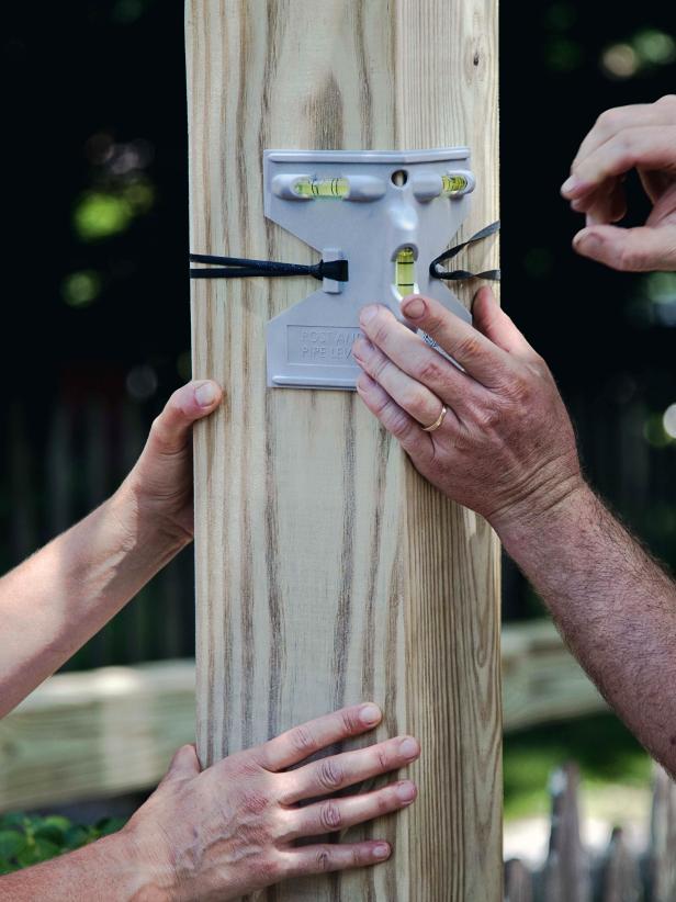 Use a post level to ensure that they're straight, and then secure in place with decking screws and lag bolts on each side.