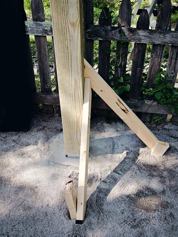 Stabilize the posts by attaching 2x4's to adjacent sides of the post to hold in place for the next step.