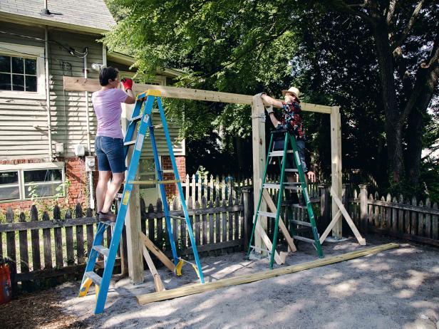 Next, grab a friend to help place the 2x6x16 beams on the notches at the top of the posts.