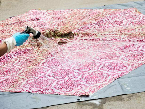 Use a handheld scrub brush to clean the entire umbrella. Let it soak for 10 minutes. Rinse off umbrella with a water hose and then allow to fully dry.