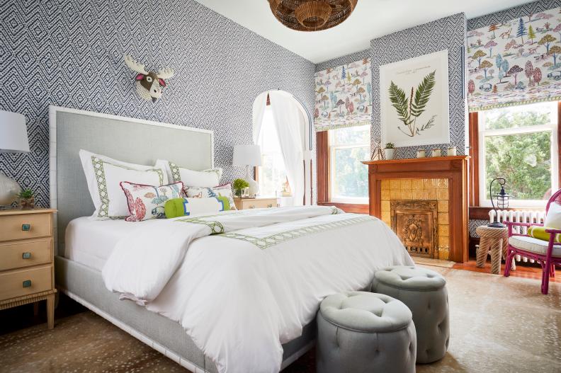 Teen Bedroom With Patterned Wallpaper And Fireplace Beside Bed
