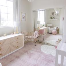 Pink and White Nursery With Sheepskin