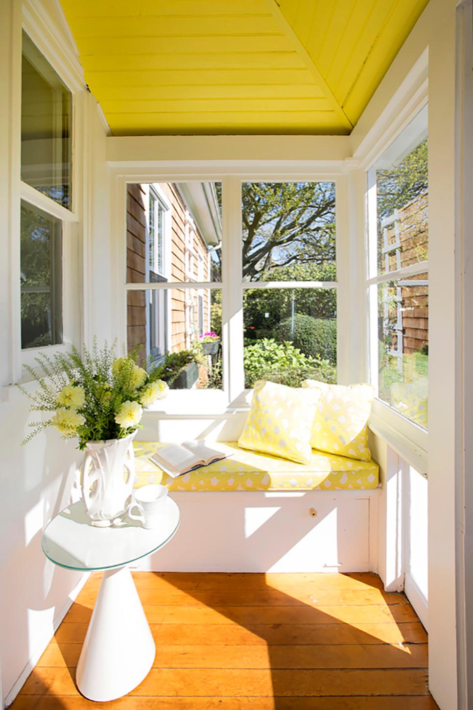 Bright Yellow Sunroom With Window Bench | HGTV