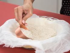 Keep your pie crust looking perfect with a pie weight. Place a cheesecloth or parchment paper on top of the crust and top with uncooked rice, and bake as usual. The rice will absorb the butter and oil from crust, so you can incorporate the rice in your favorite dish.