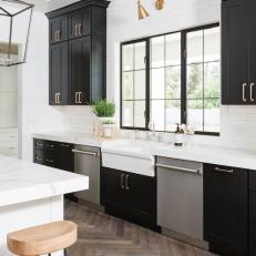 Black and White Chef Kitchen With Bronze Sconce