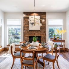 Dining Room With Wood Paneled Fireplace