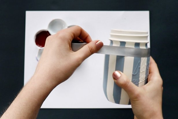 Mask off horizontal stripes using washi tape. Paint between the stripes using the same color paint. Remove the tape and let dry completely.