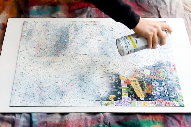 Put together a puzzle. Place it on a sheet of foam core and spray paint it white. Add several light coats of spray paint to get even coverage.