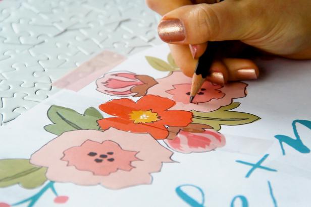 Draw or print out your design. If you’ve printed your image, color on the back with a pencil. Then tape it into place on the puzzle and trace over all of the outlines to transfer the design.