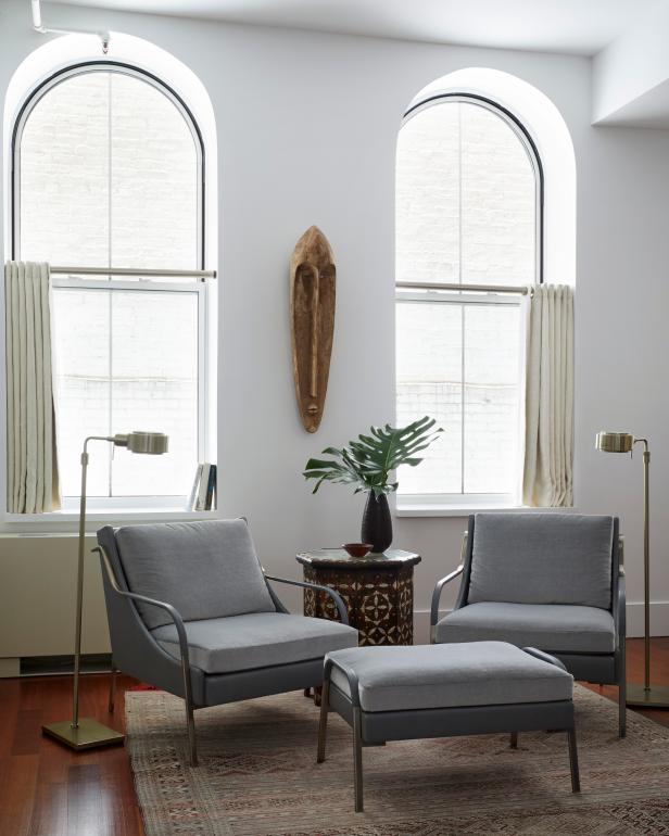 Two Large Windows Above Modern Armchairs With Lamps In Reading Nook