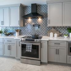 Gray Kitchen With Decorative Counter-To-Ceiling Backsplash