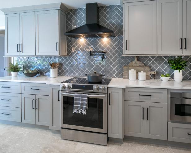 Gray Kitchen With Decorative Counter To Ceiling Backsplash