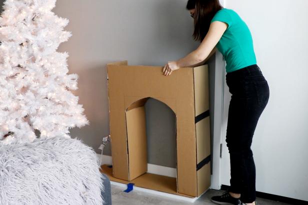 Repeat steps from step 3 to add cardboard rectangles to the outside of the fireplace. Reinforce with cardboard supports as needed so the fireplace keeps its shape.