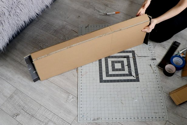 Draw your mantelpiece shape on another large piece of cardboard. Cut it out and glue and tape it together.