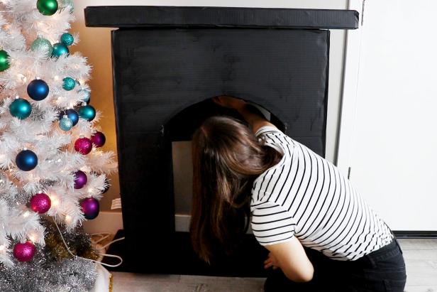 Spray paint black. Once dry, bring inside and tape black paper to the wall behind the fireplace.