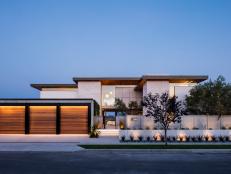 Modern Home Exterior With Three-Car Garage And Simple Landscaping