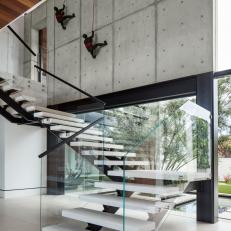 Modern Glass Staircase With Wall Sculptures