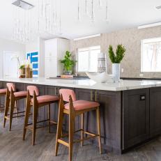 White Open Plan Kitchen With Pink Barstools