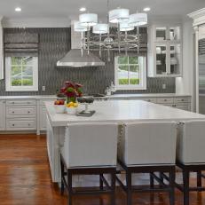 Gray and White Chef Kitchen With Wood Floors