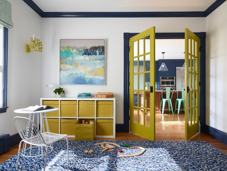 Playroom With Bold Accents And French Doors Leading To Large Area Rug
