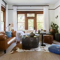 Neutral Rustic Living Room With Blue Ottoman